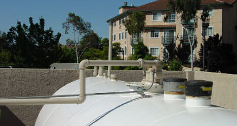 Close up of the top of an above-ground commercial fuel storage tank & pump
