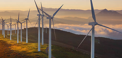 Photo of multiple wind turbines on a hilltop