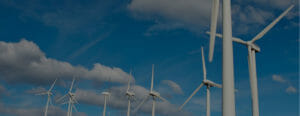 Photo of 9 windmill turbines in front of sky