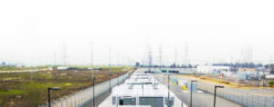 Photo of a power substation with electrical towers in the background