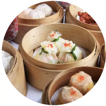 Dim sum containers with dumplings inside